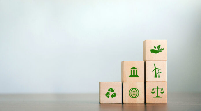 ESG Concepts on Environment, Society and Governance Revolving Sustainable Organization Development Wooden block with environmental ESG icon on gray background. copy space corporate social responsibility