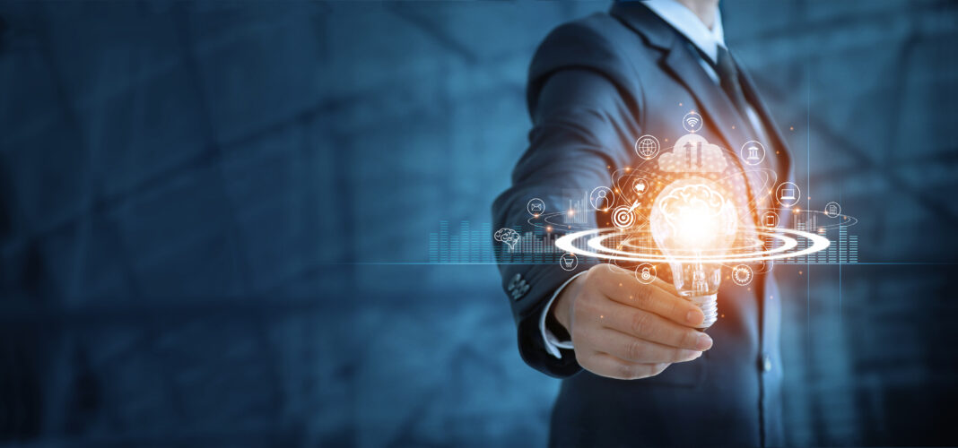 Businessman holding light bulb and virtual brain with network of business, Modern executive management on positive attitude, Growth mindset and developed new era in organization.